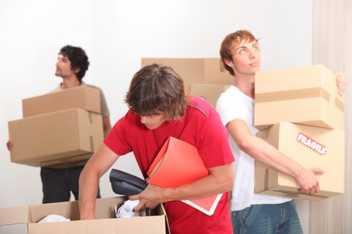 Packed boxes and furniture being loaded into a moving van in Walthamstow