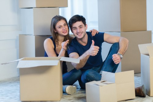 Local movers transporting household items near a Walthamstow property