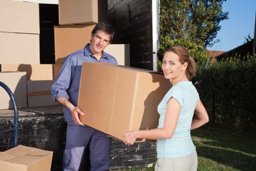 House removalists handling furniture in a Walthamstow home
